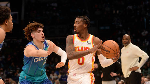 Jan 23, 2022; Charlotte, North Carolina, USA; Atlanta Hawks guard Delon Wright (0) looks to pass as he is defended by Charlotte Hornets guard LaMelo Ball (2) during the first half against the Charlotte Hornets at The Spectrum Center.